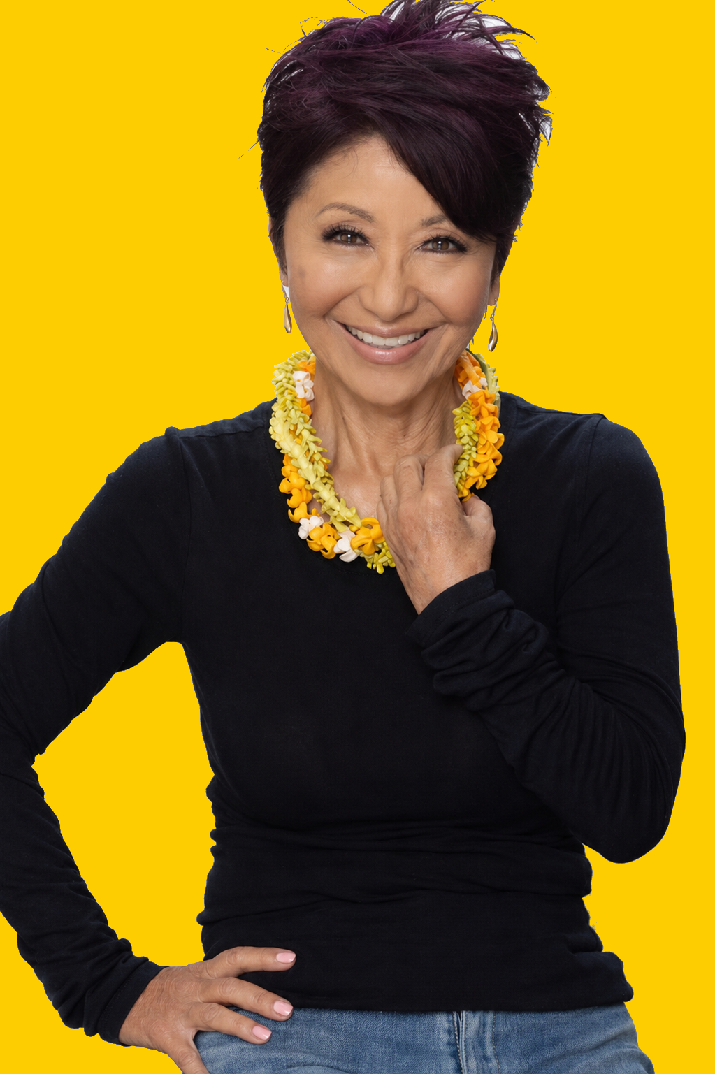 Olelo pa'a Ogawa, founder of Glow Hawaii, smiling warmly in a pink floral scarf